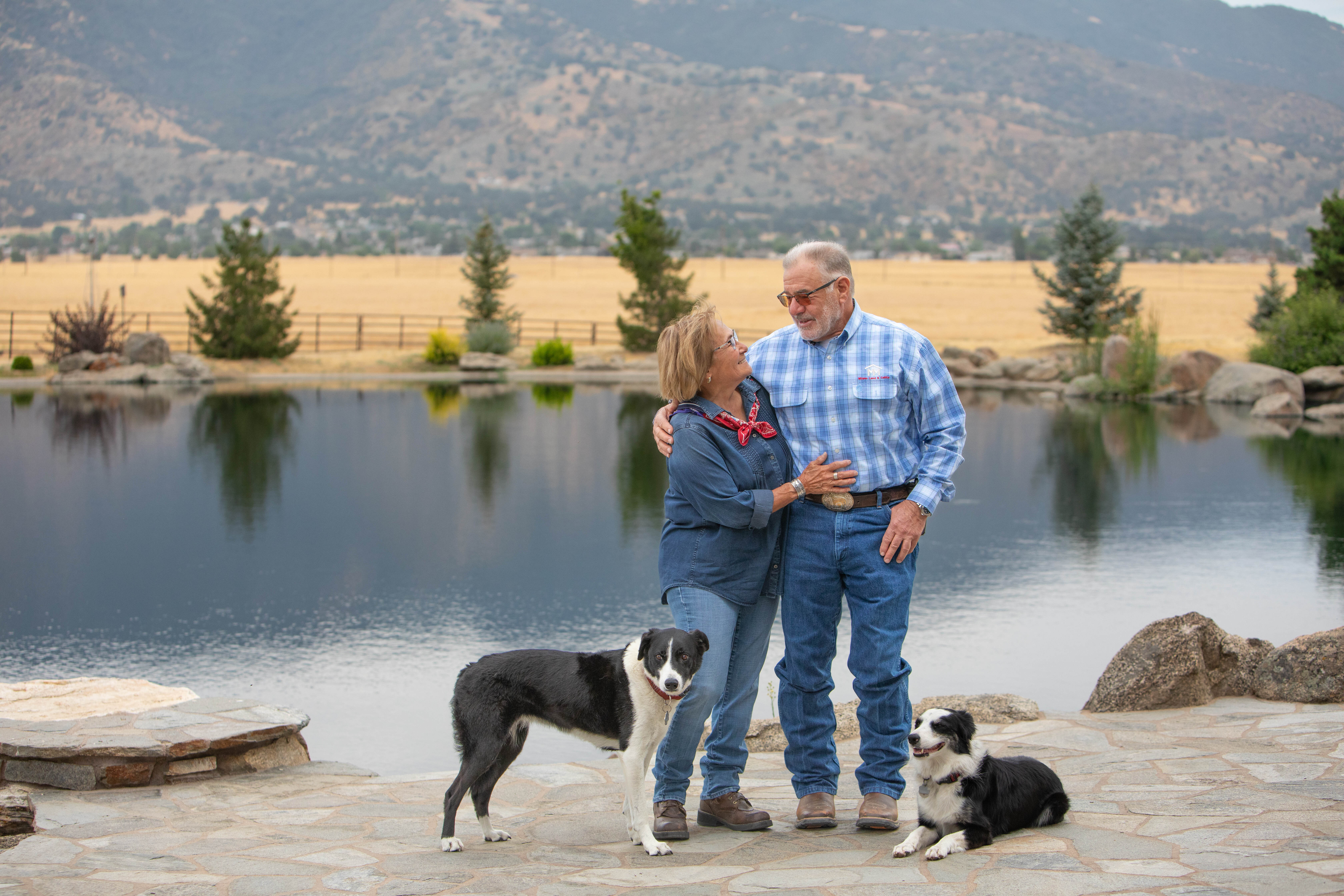 Jessie and Mark Milano with their dogs on their ranch.