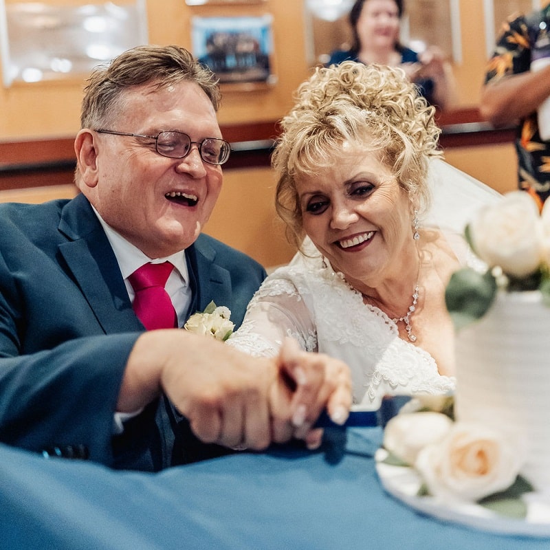 Robert Shupe and Marino Callahan cut their wedding cake.