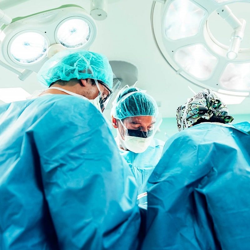 Three surgeons in an operating room.